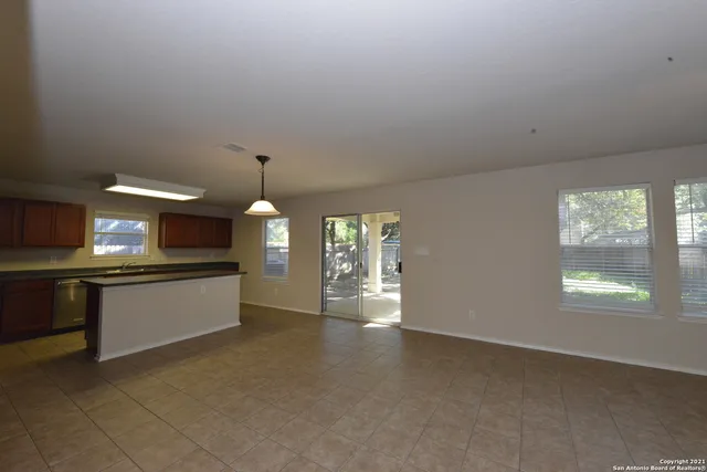 a kitchen view with fireplace and window