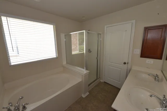 a bathroom with a bathtub and a sink