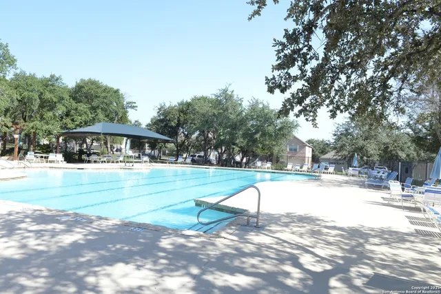 a view of swimming pool with outdoor seating and yard