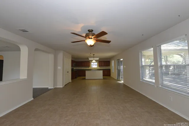 a view of a livingroom with a ceiling fan and window