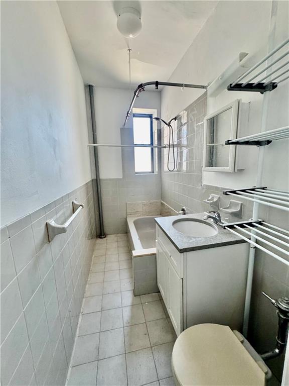 7501 Ridge Boulevard, Unit 2E Brooklyn, NY 11209 - Photo 12 of 13 a bathroom with a sink a toilet and a shower