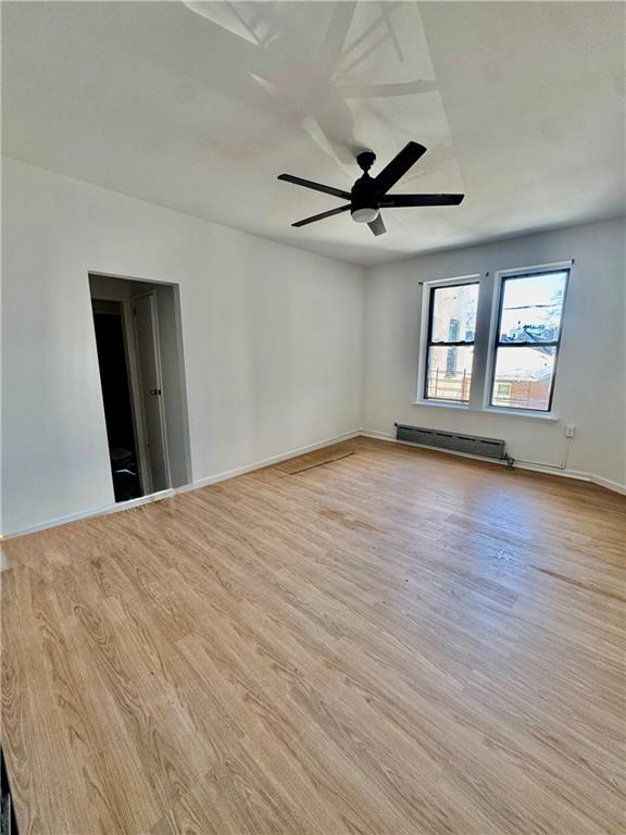 7501 Ridge Boulevard, Unit 2E Brooklyn, NY 11209 - Photo 6 of 13 wooden floor in an empty room with a window