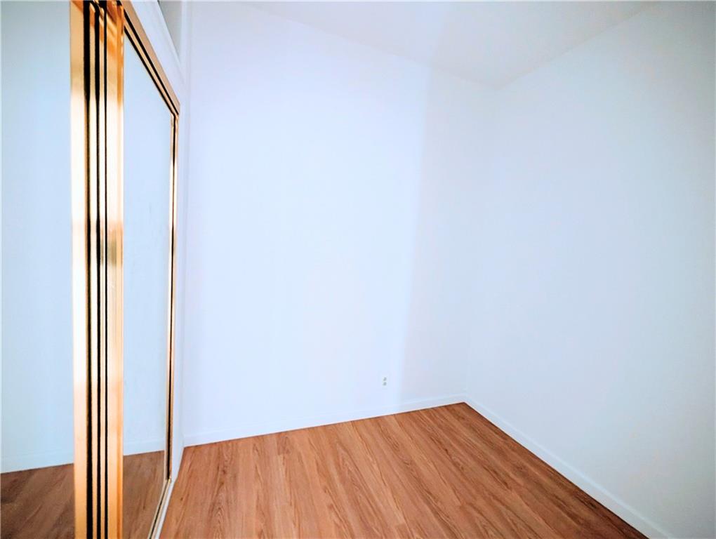7501 Ridge Boulevard, Unit 2E Brooklyn, NY 11209 - Photo 8 of 13 a view of a small space with wooden floor and a window