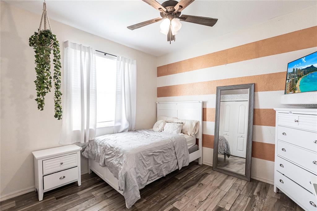 27199 Punta Cabello Court Punta Gorda, FL 33983 - Photo 24 of 45 a bedroom with a bed and a chandelier