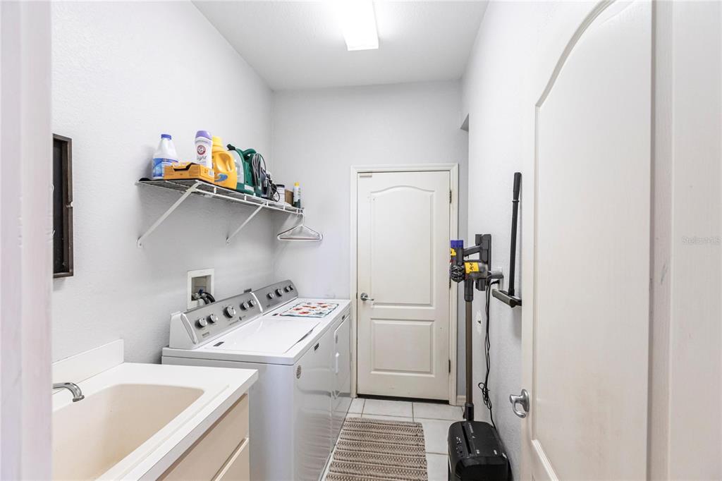 27199 Punta Cabello Court Punta Gorda, FL 33983 - Photo 37 of 45 a view of a bathroom with sink dryer and washer