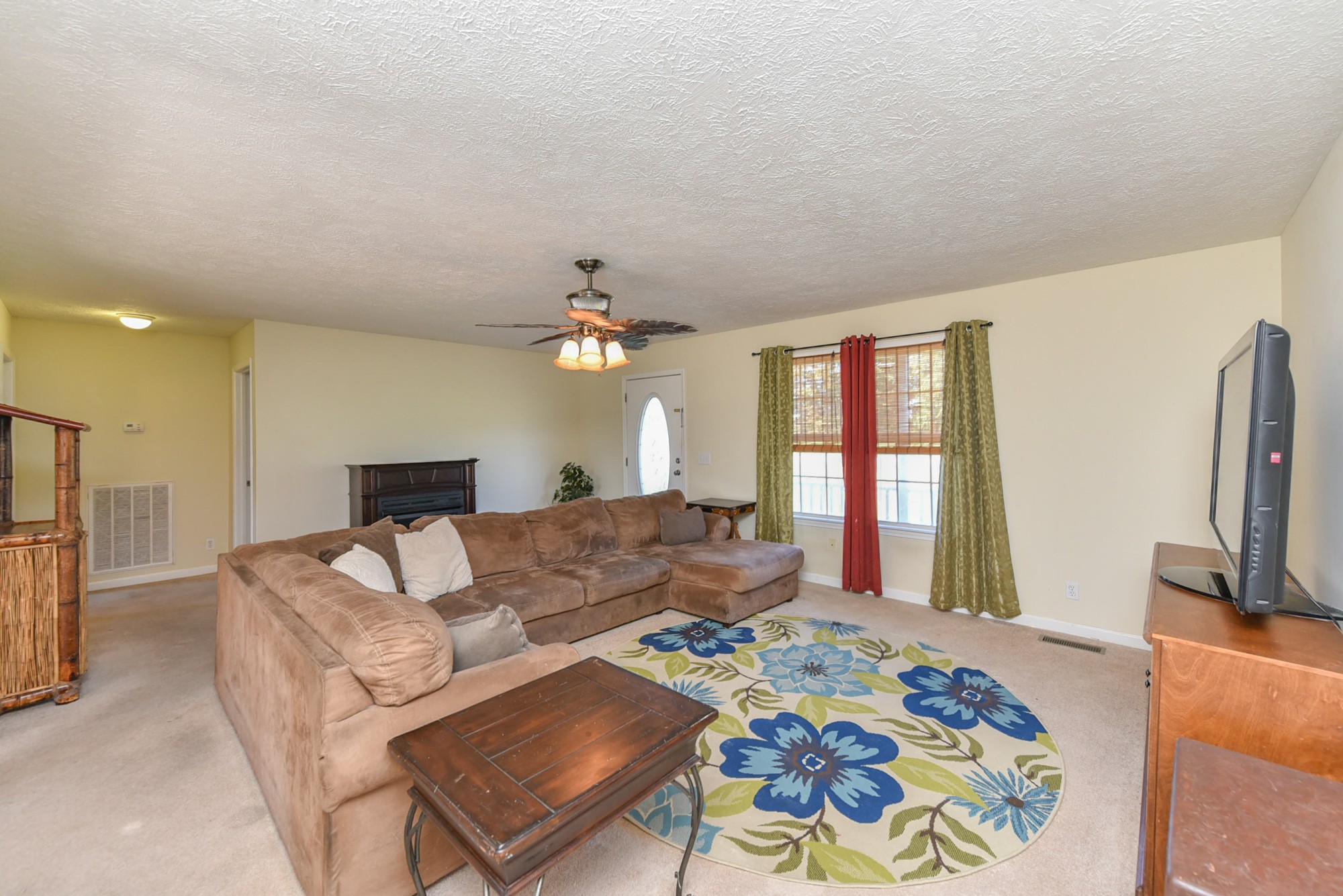 181 Spry Road Morrison, TN 37357 - Photo 8 of 25 a living room with furniture a flat screen tv and a table