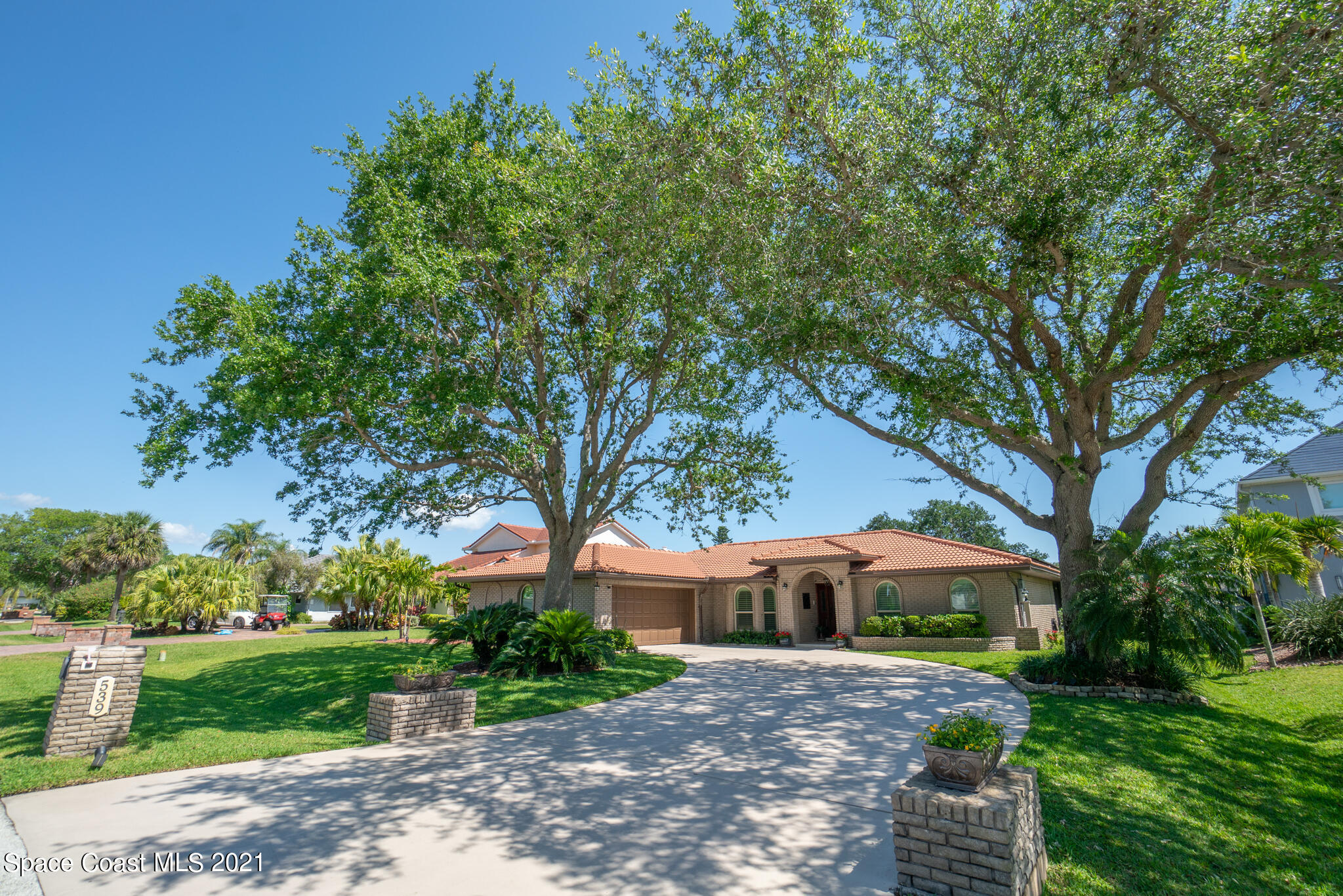 539 Lanternback Island Drive Satellite Beach, FL 32937 - Photo 1 of 54 a front view of a house with a garden