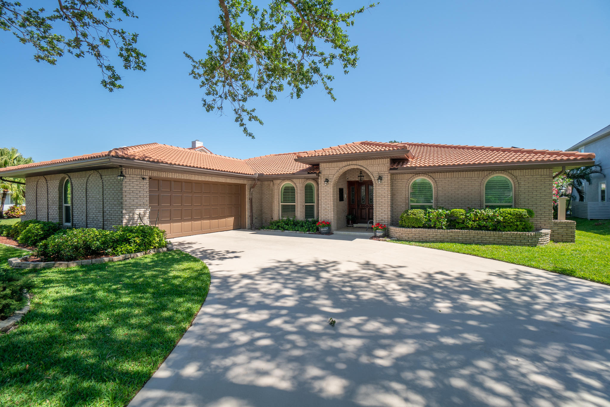 539 Lanternback Island Drive Satellite Beach, FL 32937 - Photo 2 of 54 a front view of a house with a yard and potted plants