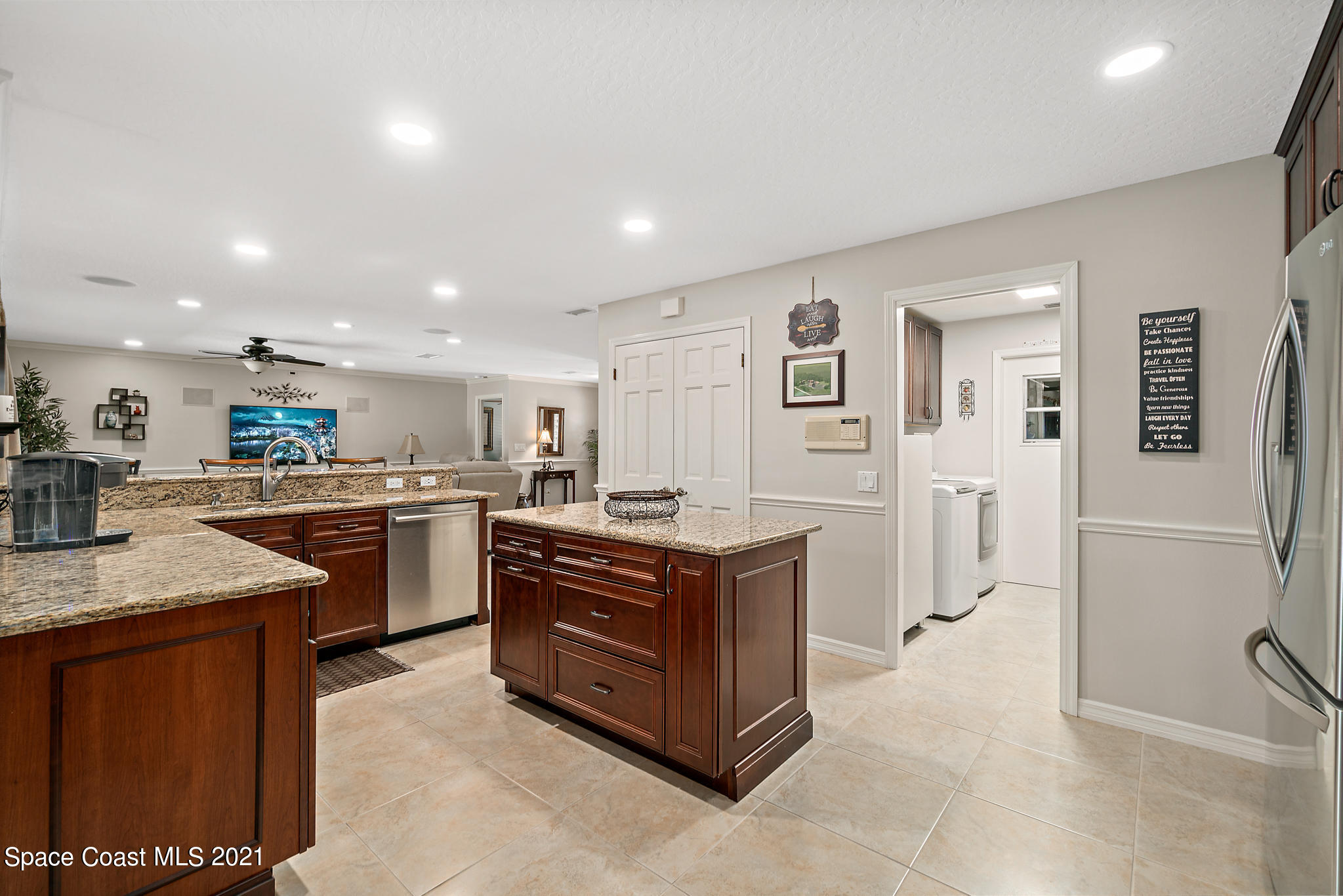 539 Lanternback Island Drive Satellite Beach, FL 32937 - Photo 12 of 54 a kitchen with stainless steel appliances granite countertop a stove and a sink