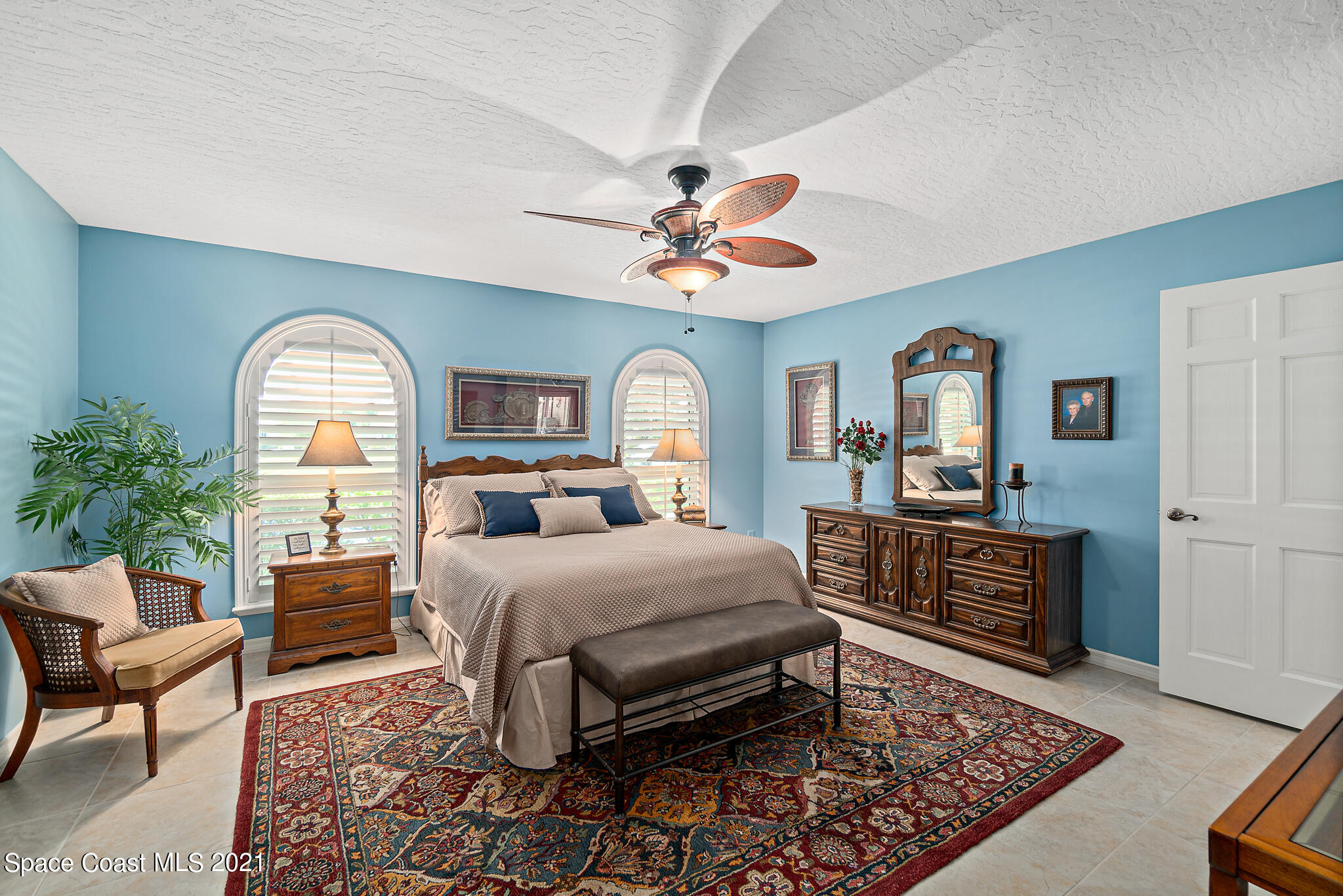 539 Lanternback Island Drive Satellite Beach, FL 32937 - Photo 19 of 54 a bedroom with a bed a dresser and chair