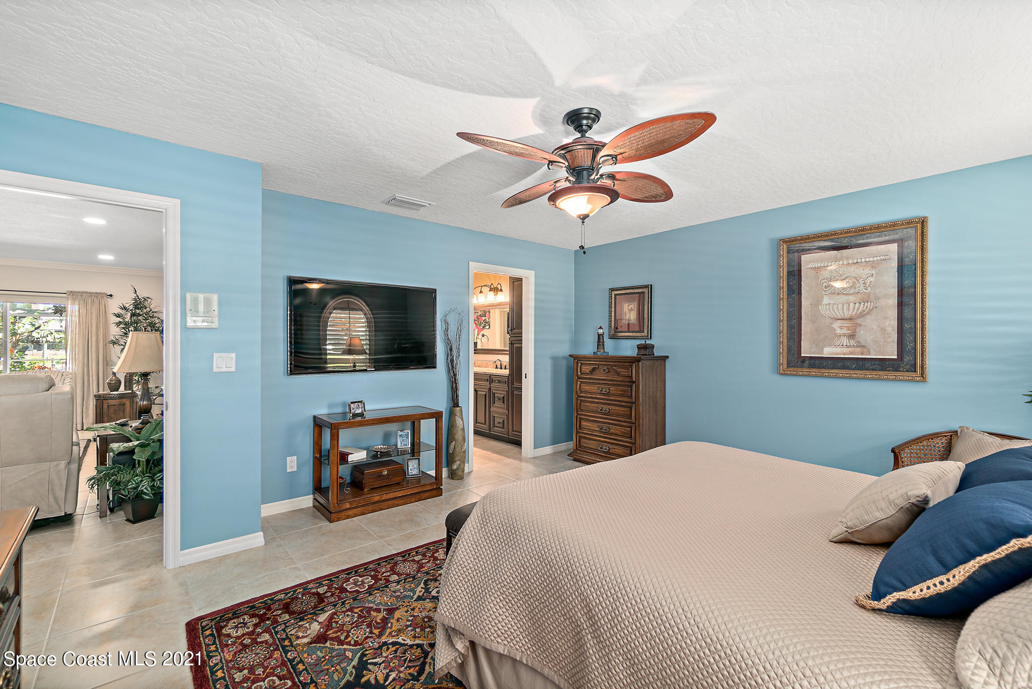 539 Lanternback Island Drive Satellite Beach, FL 32937 - Photo 20 of 54 a bedroom with a bed and a chandelier