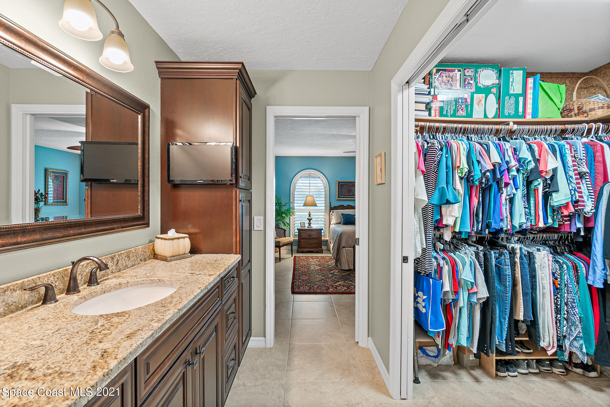 539 Lanternback Island Drive Satellite Beach, FL 32937 - Photo 21 of 54 a en suite bathroom with a granite countertop sink and a mirror