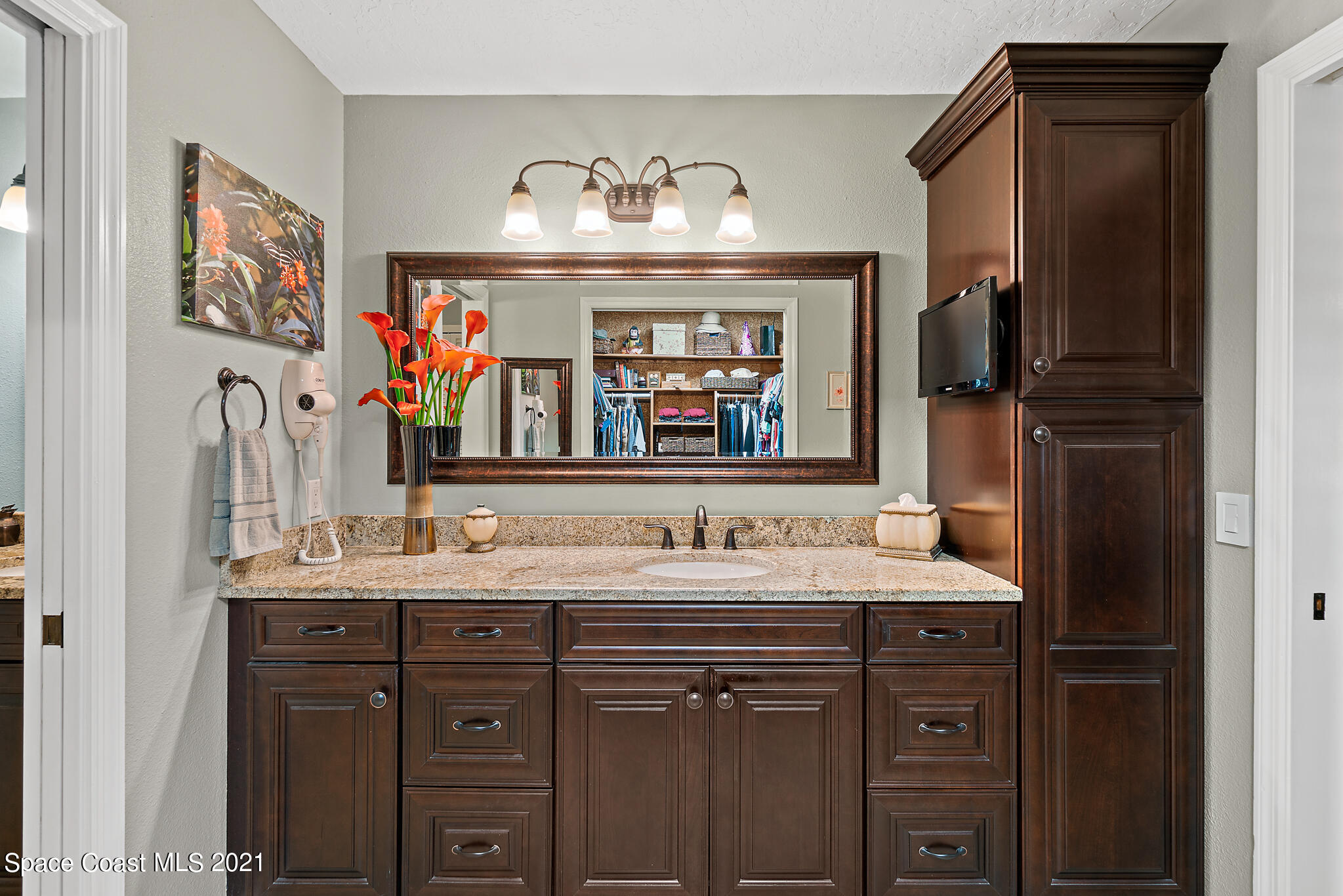 539 Lanternback Island Drive Satellite Beach, FL 32937 - Photo 22 of 54 a bathroom with a sink and a mirror