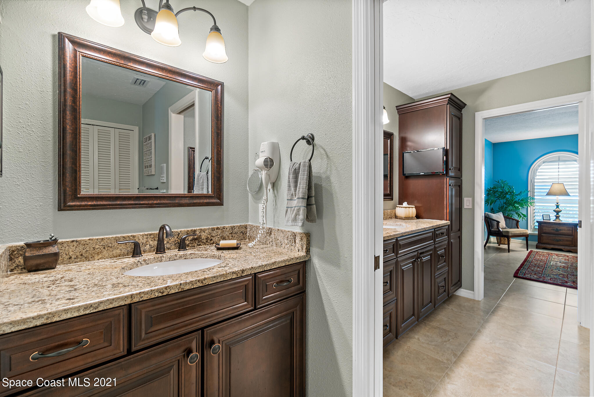 539 Lanternback Island Drive Satellite Beach, FL 32937 - Photo 24 of 54 a en suite bathroom with a granite countertop sink and a mirror