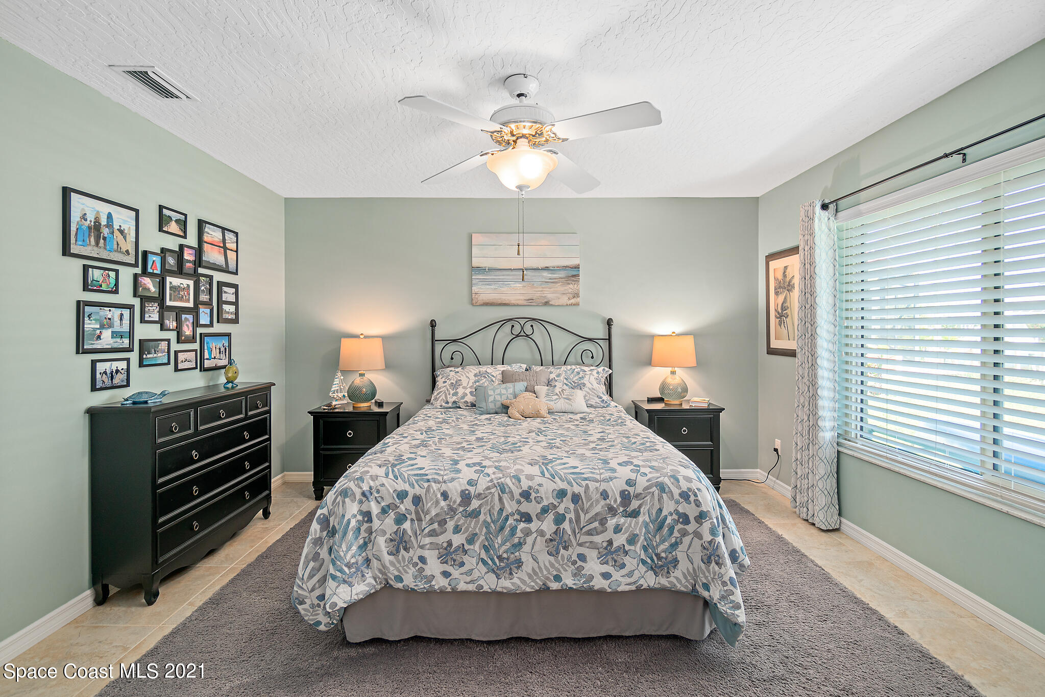 539 Lanternback Island Drive Satellite Beach, FL 32937 - Photo 26 of 54 a bedroom with a bed and a chandelier