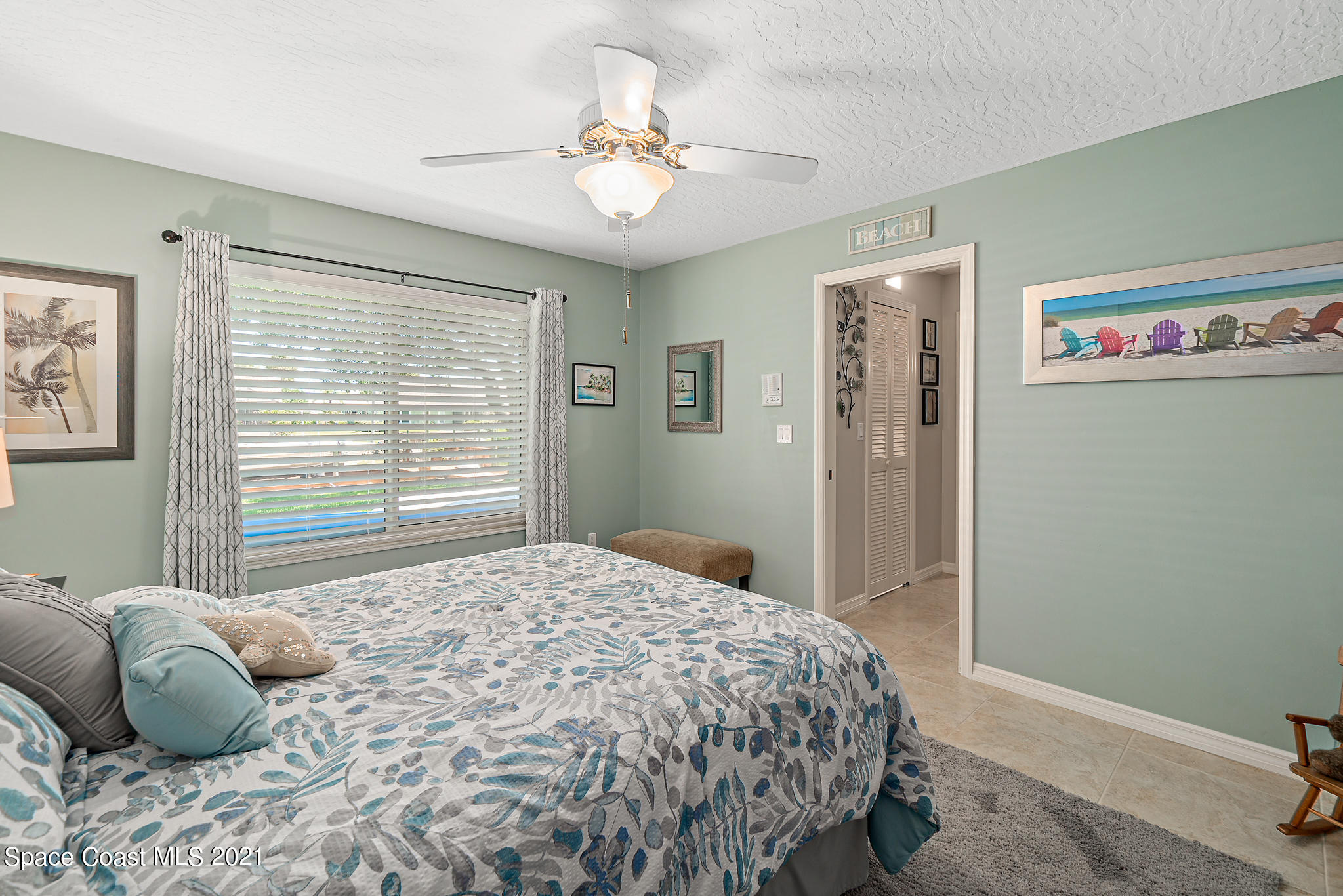 539 Lanternback Island Drive Satellite Beach, FL 32937 - Photo 27 of 54 a bedroom with a bed and a chandelier