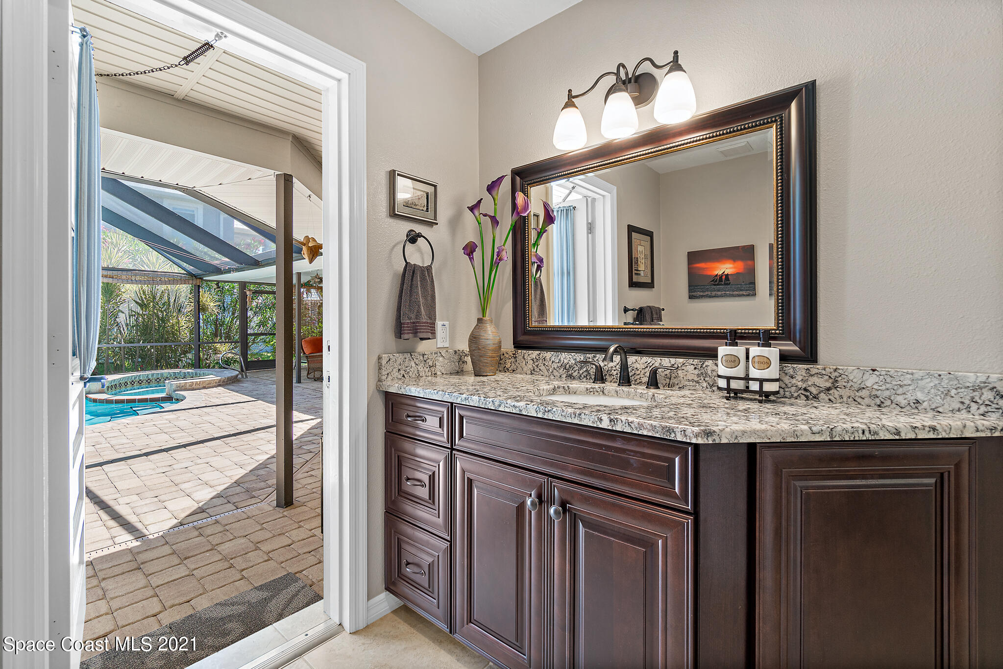 539 Lanternback Island Drive Satellite Beach, FL 32937 - Photo 28 of 54 a bathroom with a granite countertop sink and a mirror