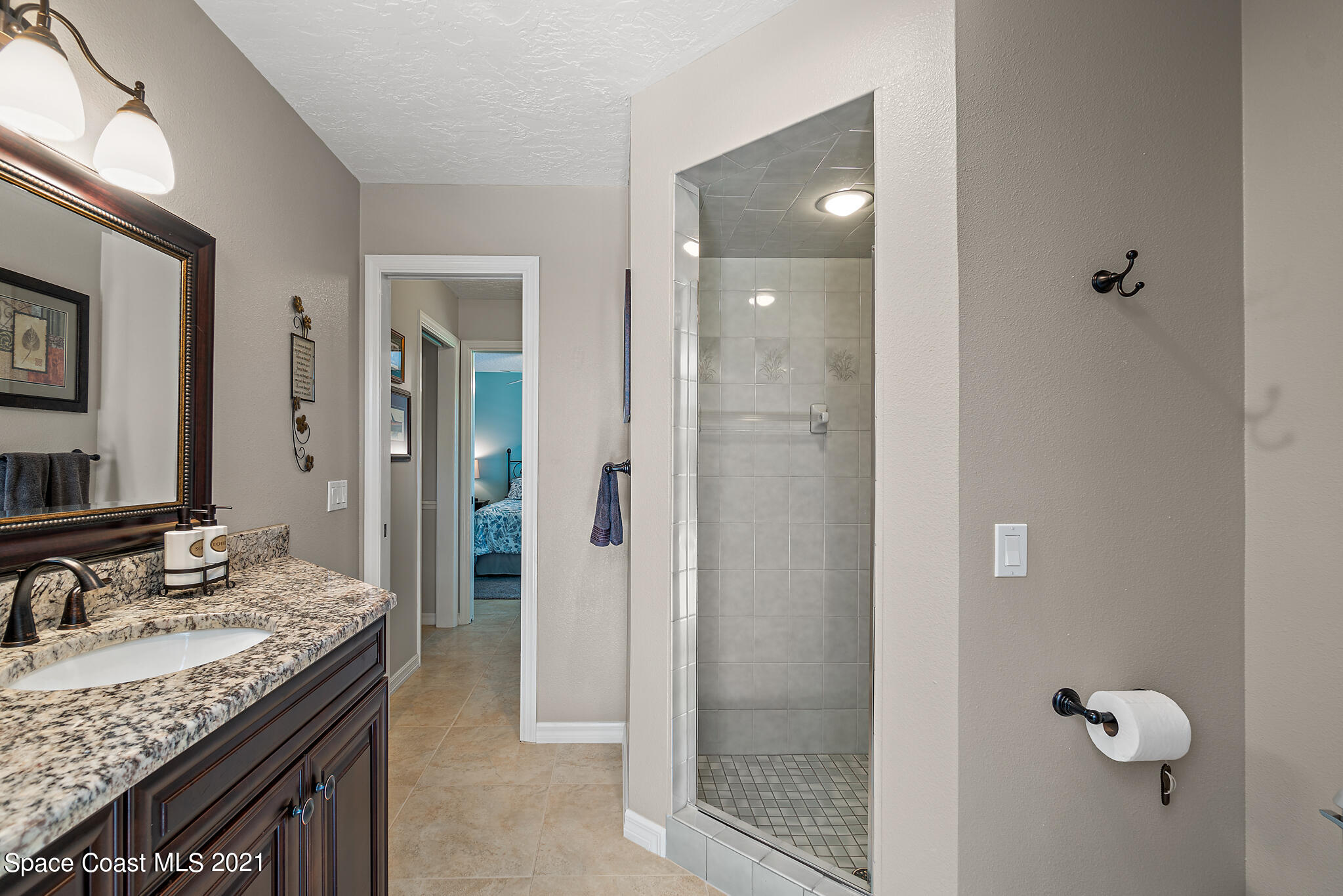539 Lanternback Island Drive Satellite Beach, FL 32937 - Photo 29 of 54 a bathroom with a granite countertop sink and a mirror
