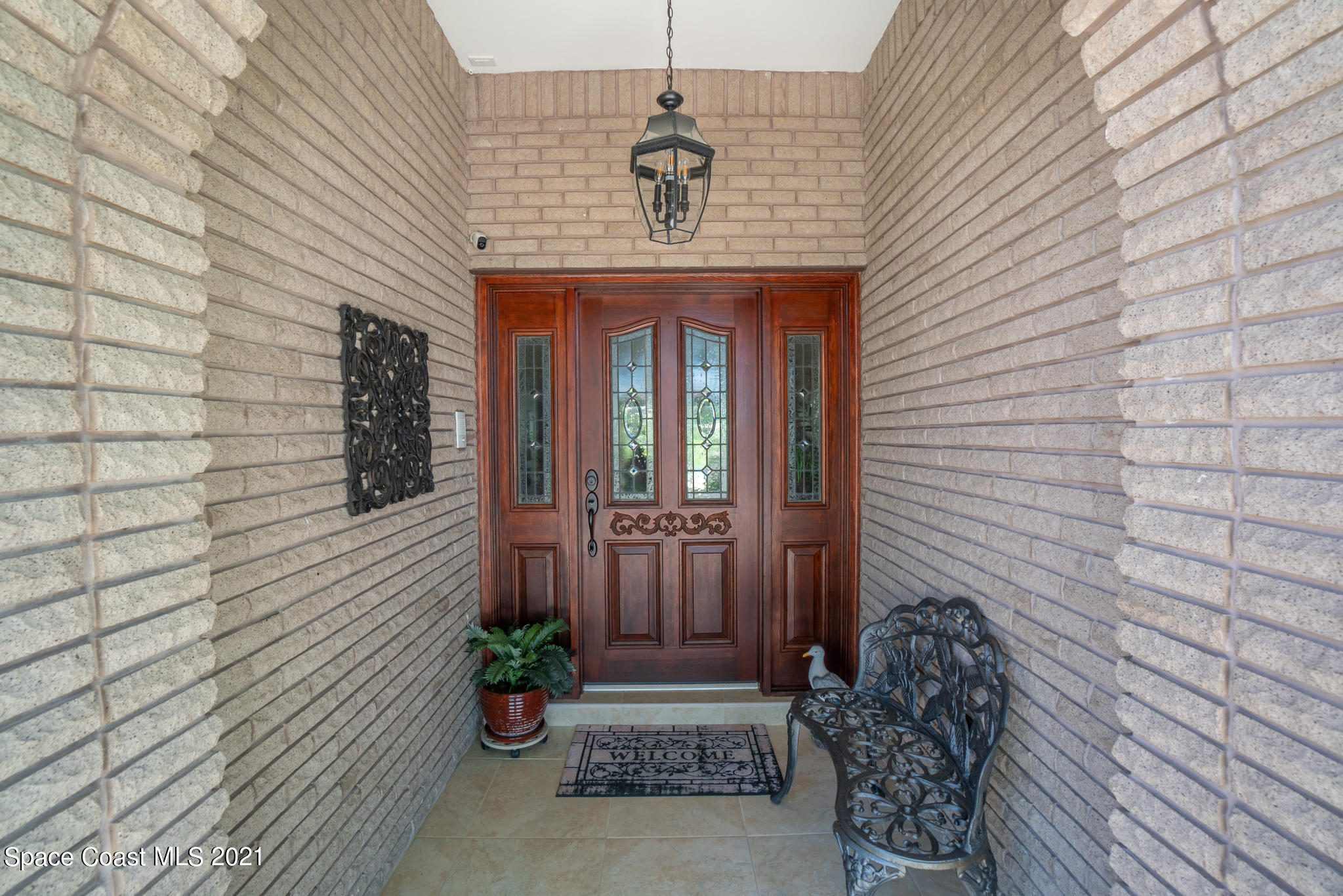 539 Lanternback Island Drive Satellite Beach, FL 32937 - Photo 4 of 54 a front view of a house with potted plants
