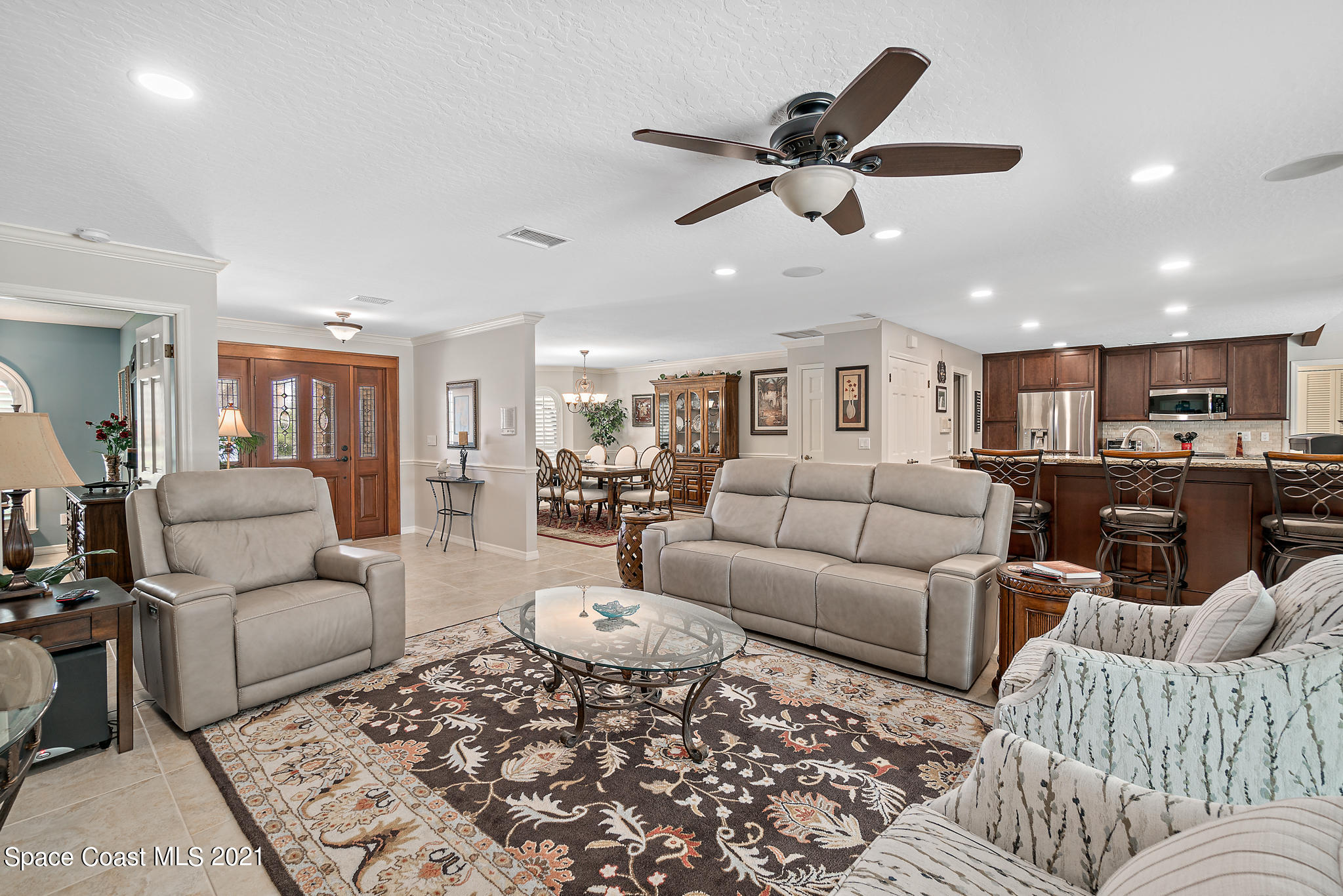 539 Lanternback Island Drive Satellite Beach, FL 32937 - Photo 7 of 54 a living room with furniture and a ceiling fan