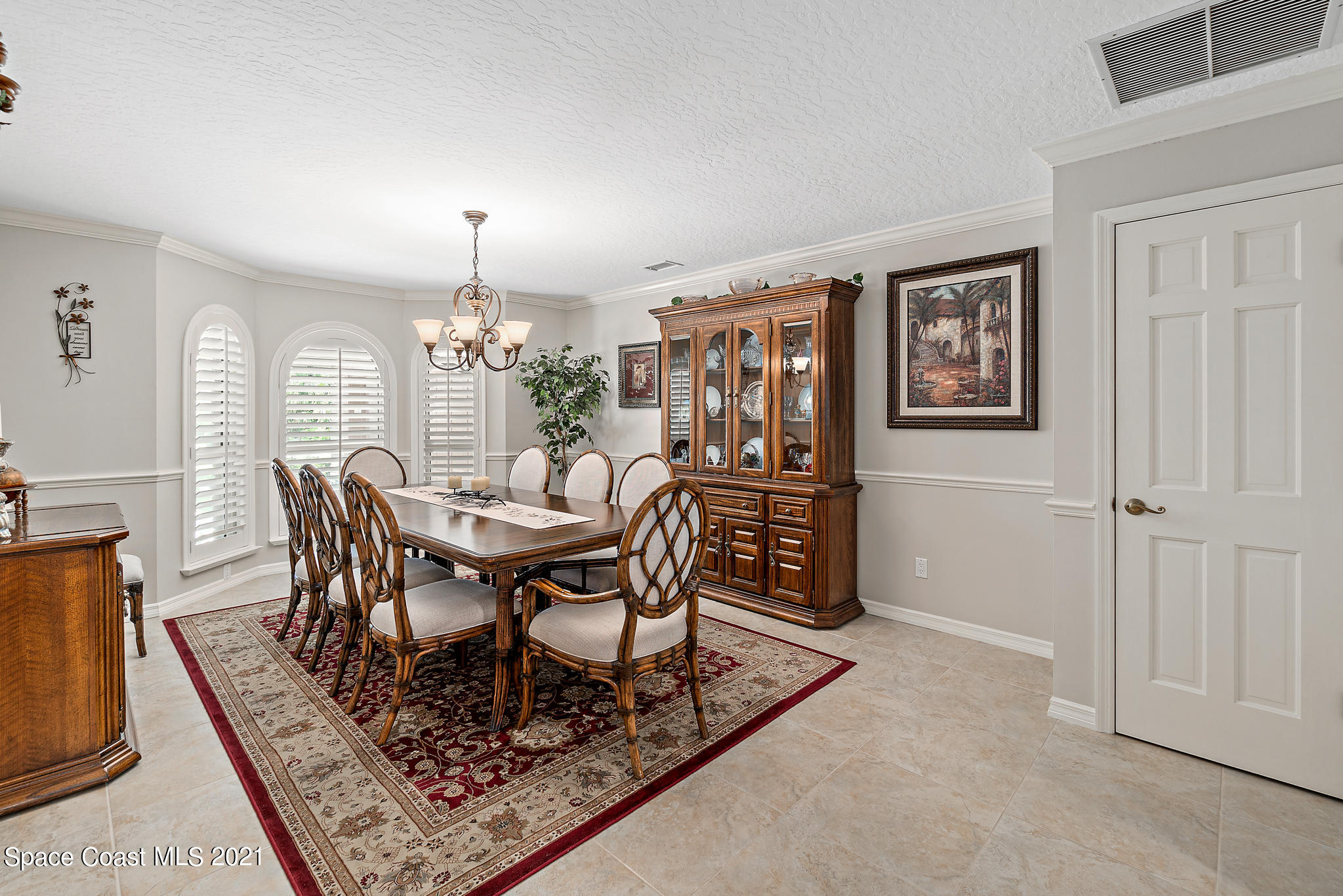 539 Lanternback Island Drive Satellite Beach, FL 32937 - Photo 9 of 54 a view of a dining room with furniture and chandelier