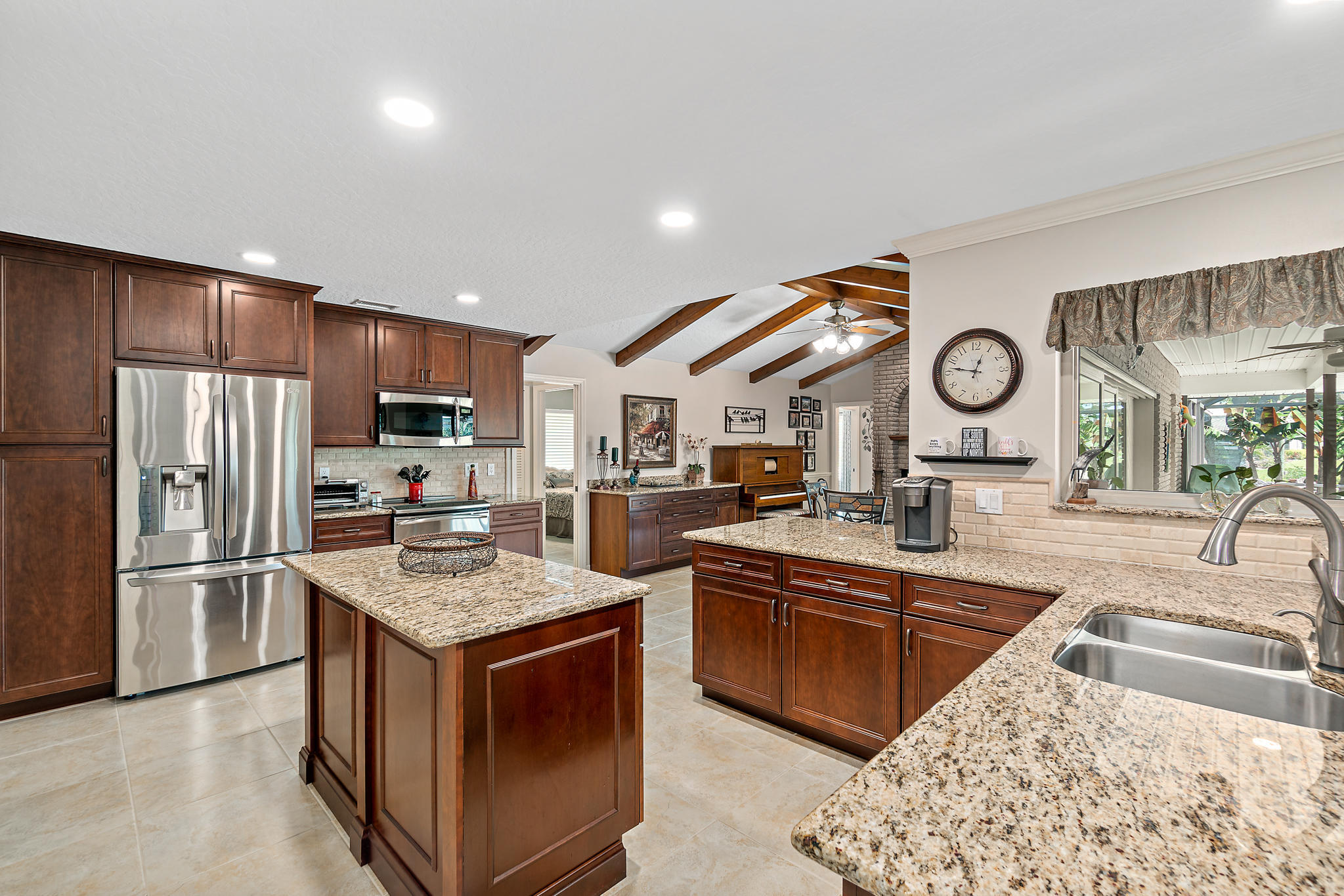 539 Lanternback Island Drive Satellite Beach, FL 32937 - Photo 10 of 54 a kitchen with stainless steel appliances granite countertop a sink stove and refrigerator