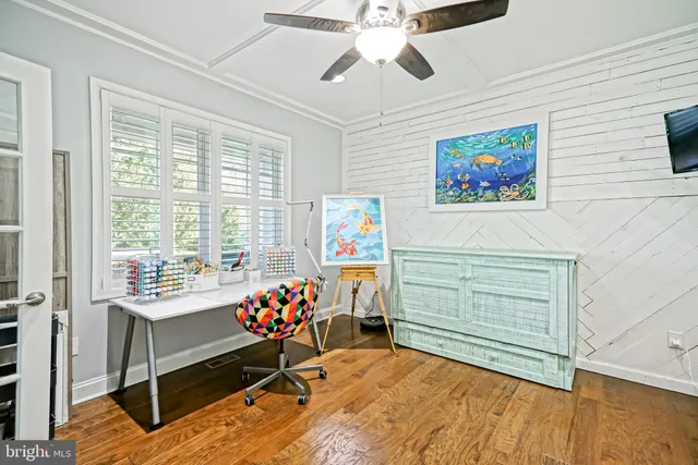 a kitchen with stainless steel appliances kitchen island granite countertop a dining table chairs and white cabinets