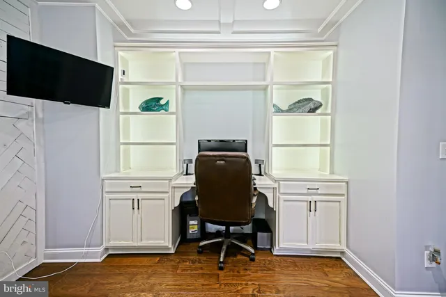 a kitchen with stainless steel appliances kitchen island granite countertop a stove a sink and a white cabinets