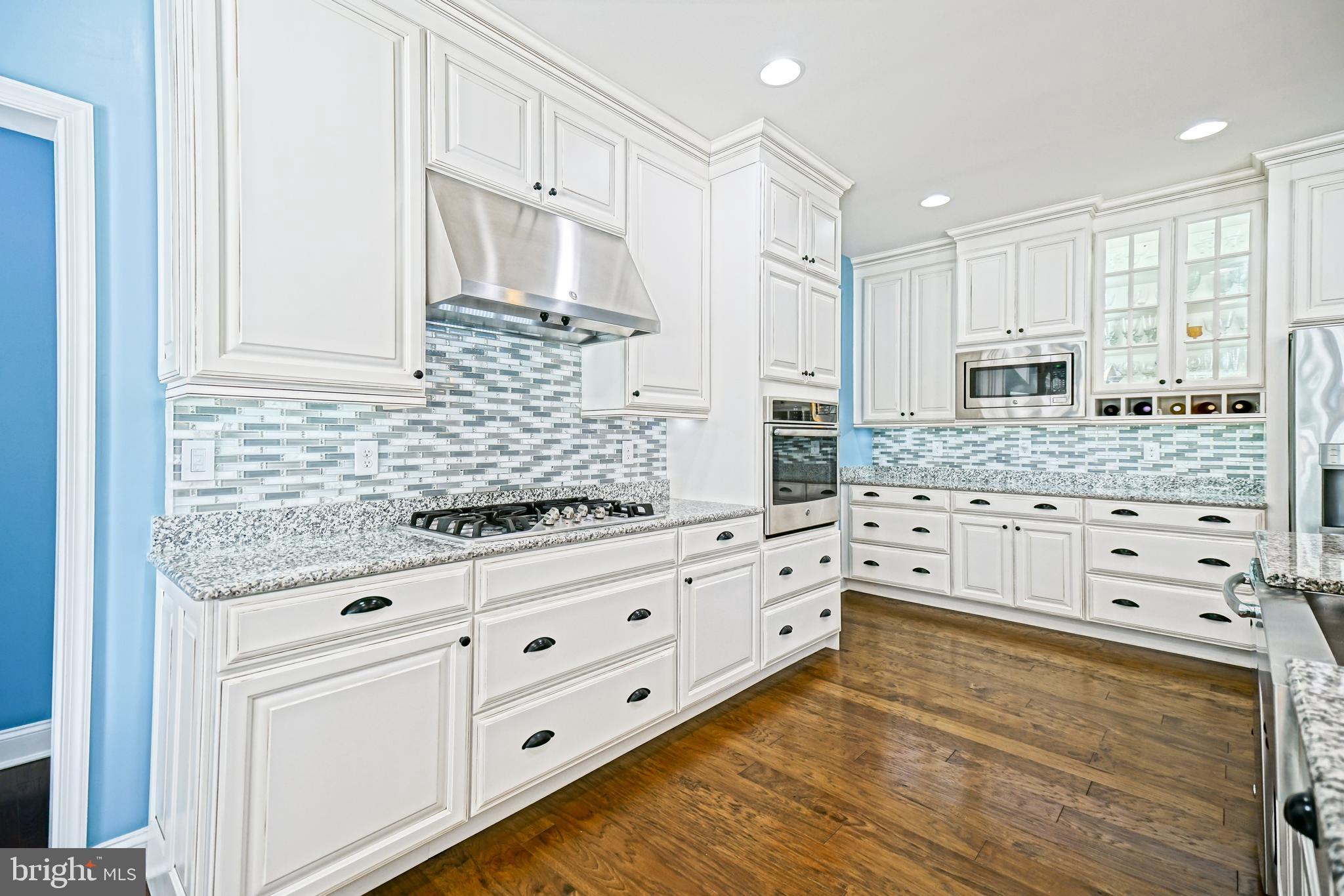 35236 Acadia Lane Lewes, DE 19958 - Photo 24 of 88 a kitchen with granite countertop white cabinets and stainless steel appliances