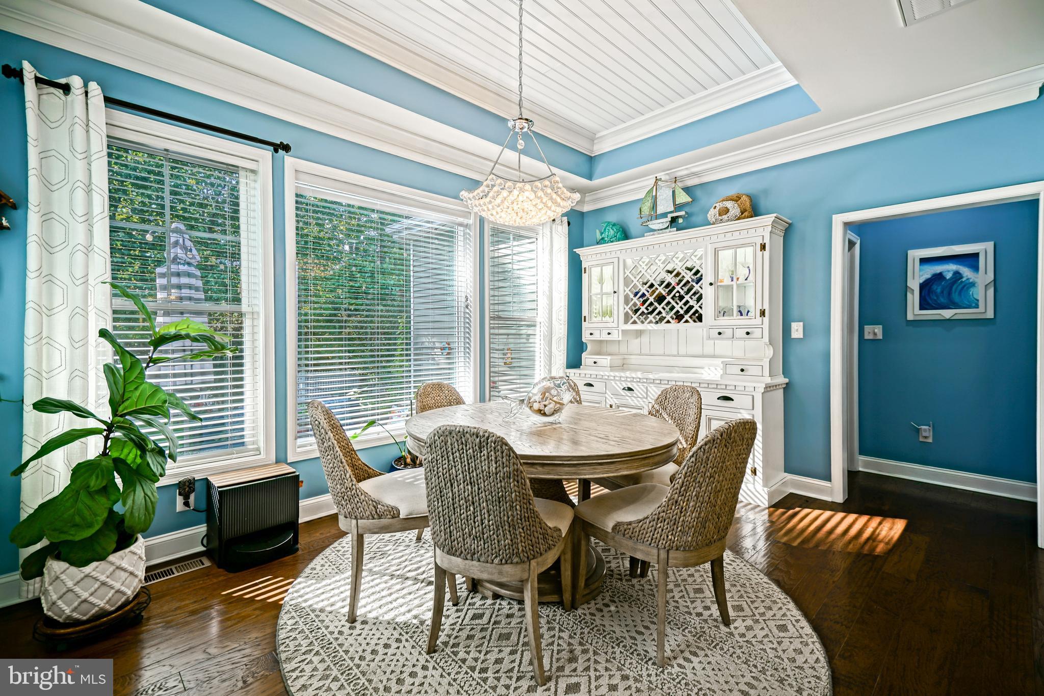 35236 Acadia Lane Lewes, DE 19958 - Photo 25 of 88 a dining room with furniture potted plants and wooden floor