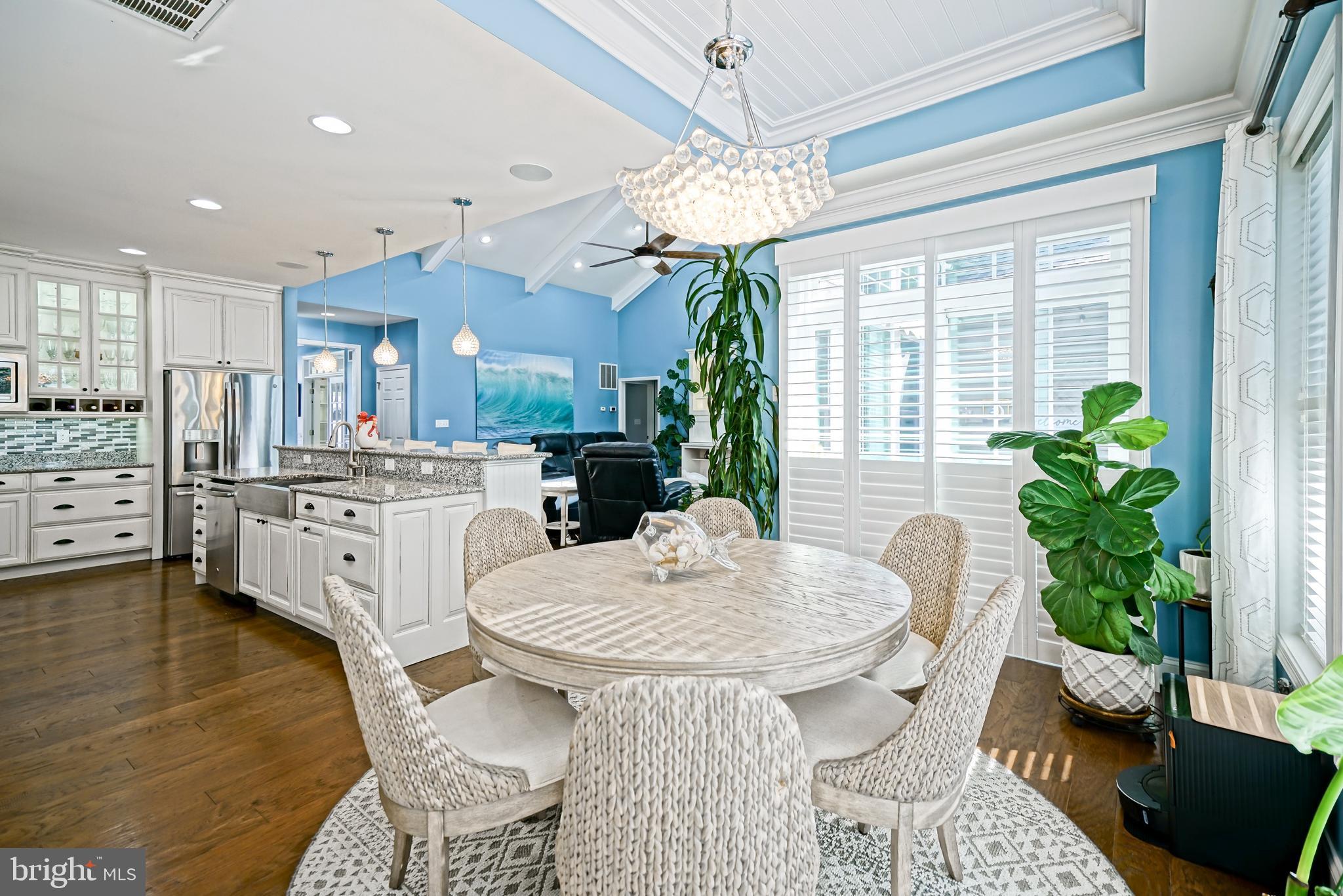 35236 Acadia Lane Lewes, DE 19958 - Photo 28 of 88 a view of a dining room with furniture and a chandelier