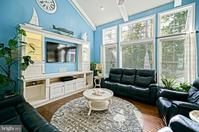 a bedroom with a bed and a flat tv screen on dresser