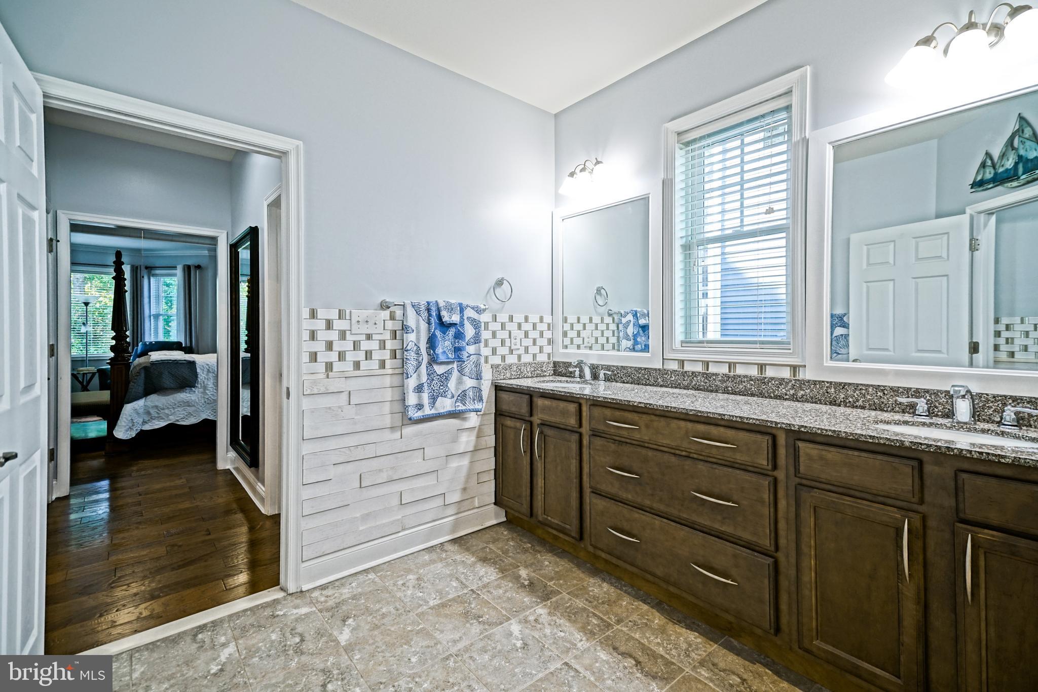 35236 Acadia Lane Lewes, DE 19958 - Photo 44 of 88 a spacious bathroom with a double vanity sink and a mirror