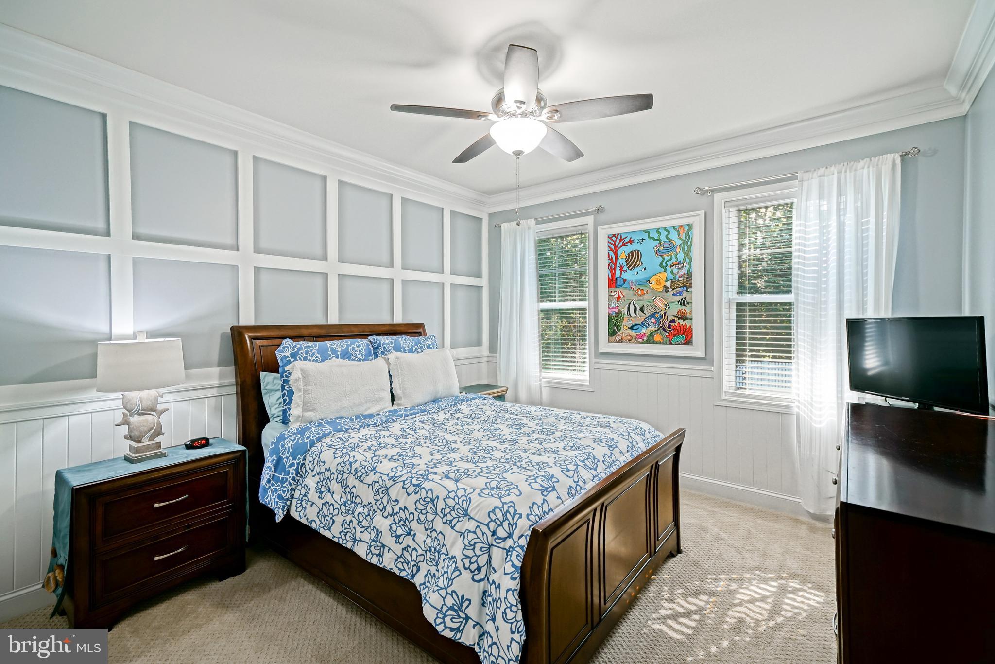 35236 Acadia Lane Lewes, DE 19958 - Photo 47 of 88 a bedroom with a bed and a flat tv screen on dresser