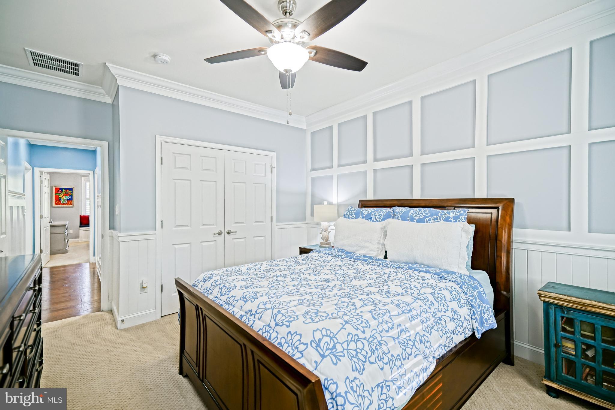 35236 Acadia Lane Lewes, DE 19958 - Photo 49 of 88 a bedroom with a large bed and a chandelier