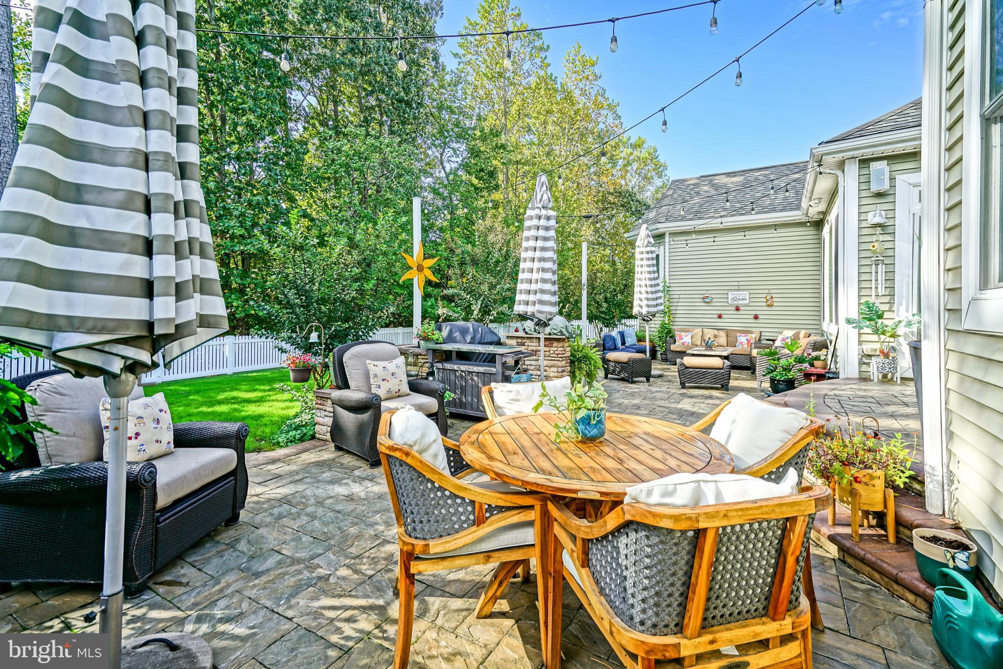 35236 Acadia Lane Lewes, DE 19958 - Photo 59 of 88 a view of a patio with couches chairs and a fire pit