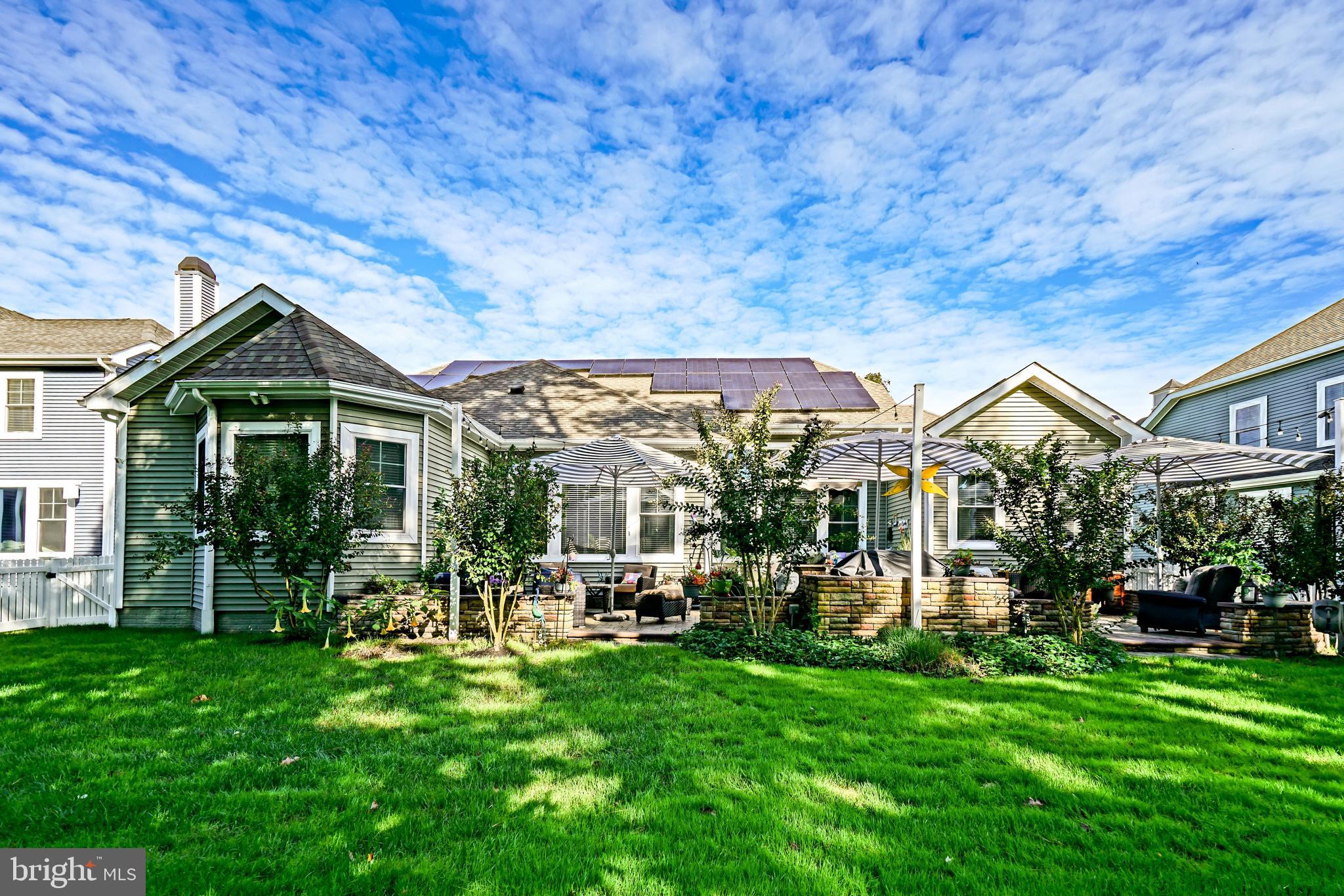 35236 Acadia Lane Lewes, DE 19958 - Photo 73 of 88 a front view of a house with a yard table and chairs