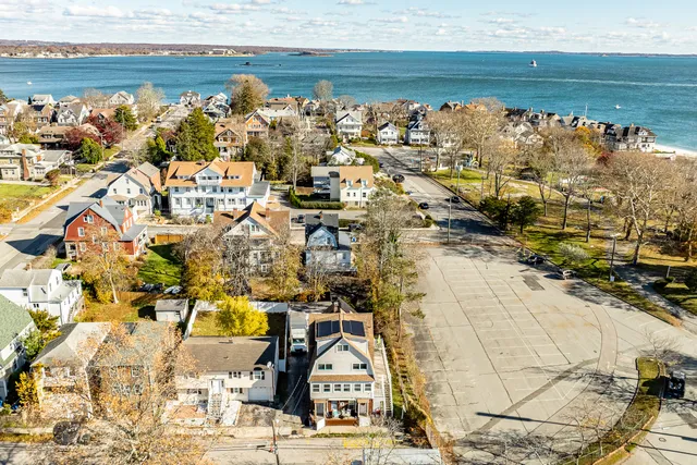 a view of a white building among the street with palm trees