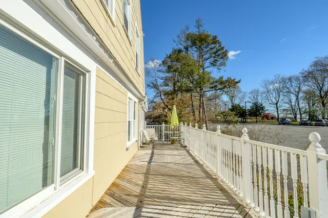 a view of a balcony with wooden floor
