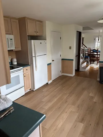 a kitchen with stainless steel appliances granite countertop a stove a sink and white cabinets