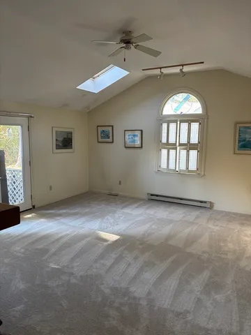 a view of an empty room with a fireplace and a window