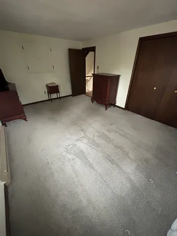 a bedroom with a bed wooden floor and window