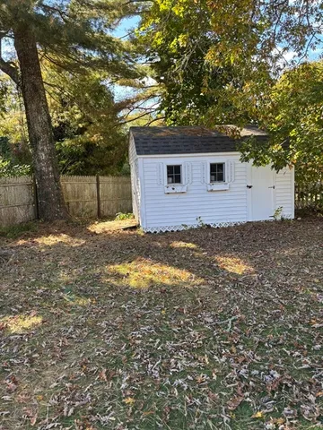 a view of a backyard with chairs and wooden floor
