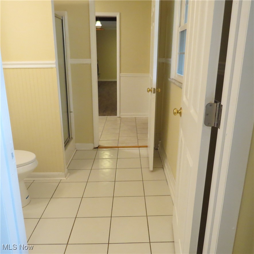 430 High Meadow Road Amherst, OH 44001 - Photo 16 of 29 Bathroom with tile patterned flooring, toilet, and an enclosed shower
