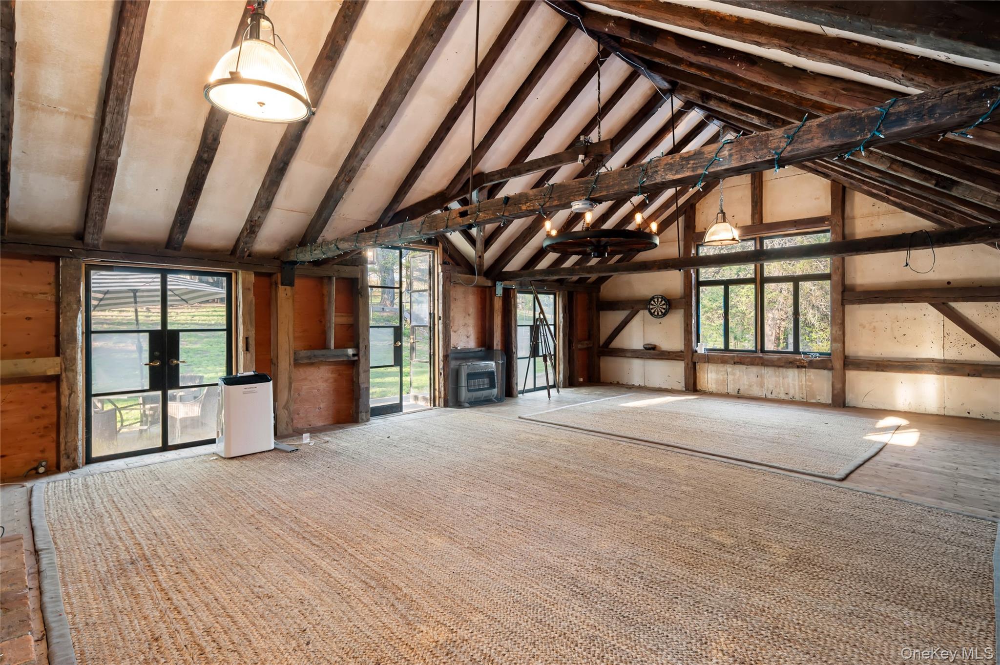 516 Pound Ridge Road Bedford, NY 10506 - Photo 41 of 46 Classic barn with a fireplace-enhanced upper level offers exceptional flex space with endless possibilities, such as a yoga studio, artist's studio, home office, wellness sanctuary, or gathering space