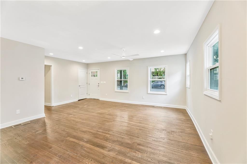1776 Temple Avenue Atlanta, GA 30337 - Photo 3 of 18 an empty room with wooden floor and windows