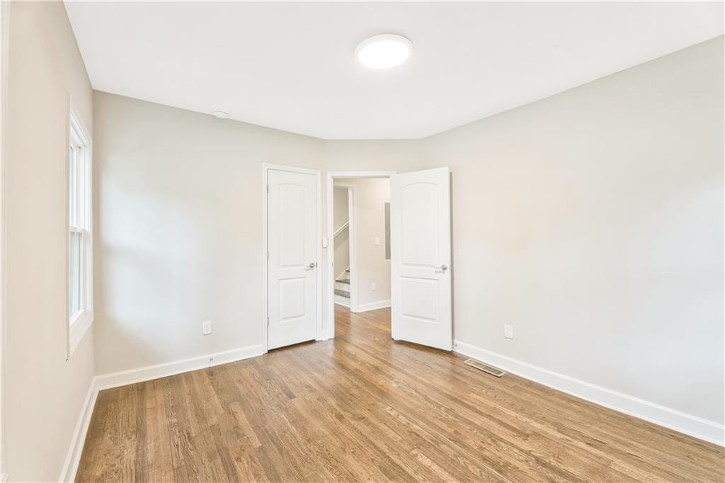 1776 Temple Avenue Atlanta, GA 30337 - Photo 7 of 18 a view of an empty room with wooden floor and closet