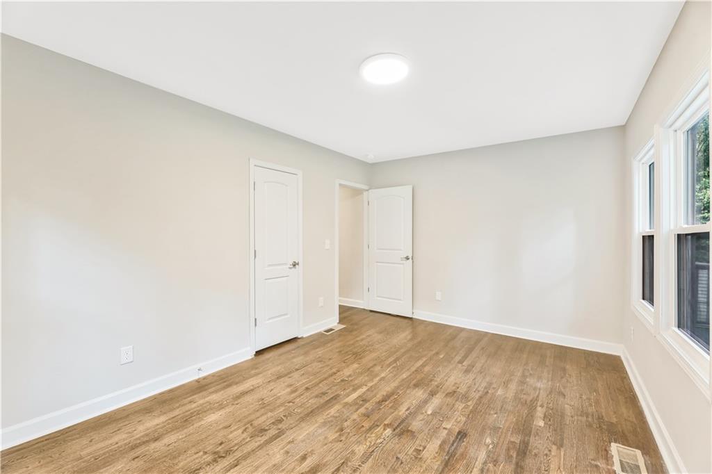 1776 Temple Avenue Atlanta, GA 30337 - Photo 9 of 18 an empty room with wooden floor and window