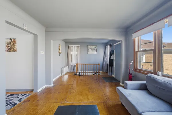 a spacious bedroom with a bed and glass window