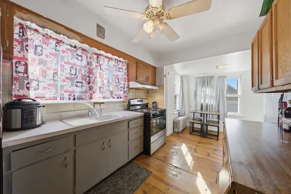 a kitchen with a sink stove and refrigerator